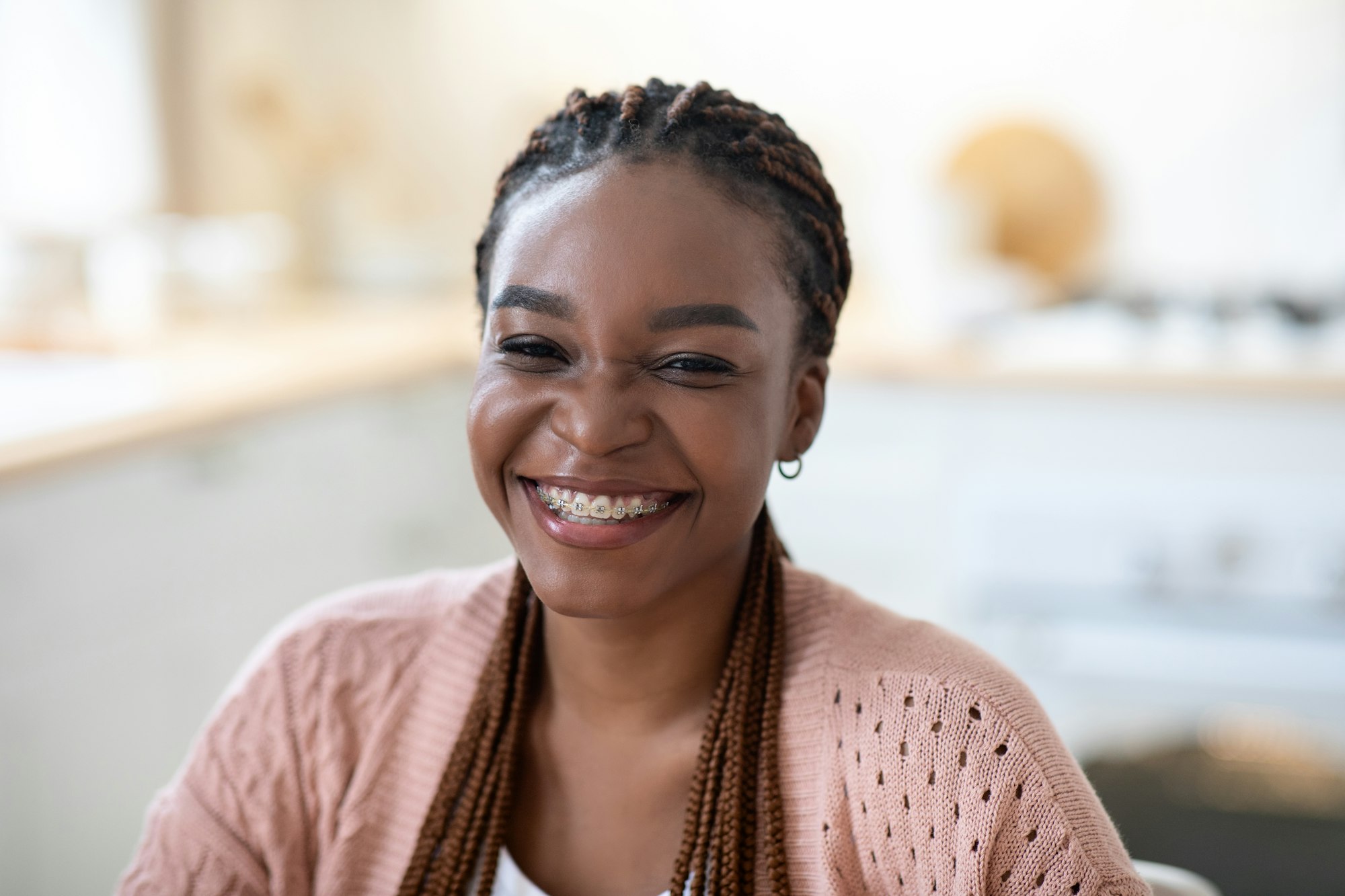 Beautiful Cheerful Black Woman With Braids And Dental Braces Posing In Kitchen