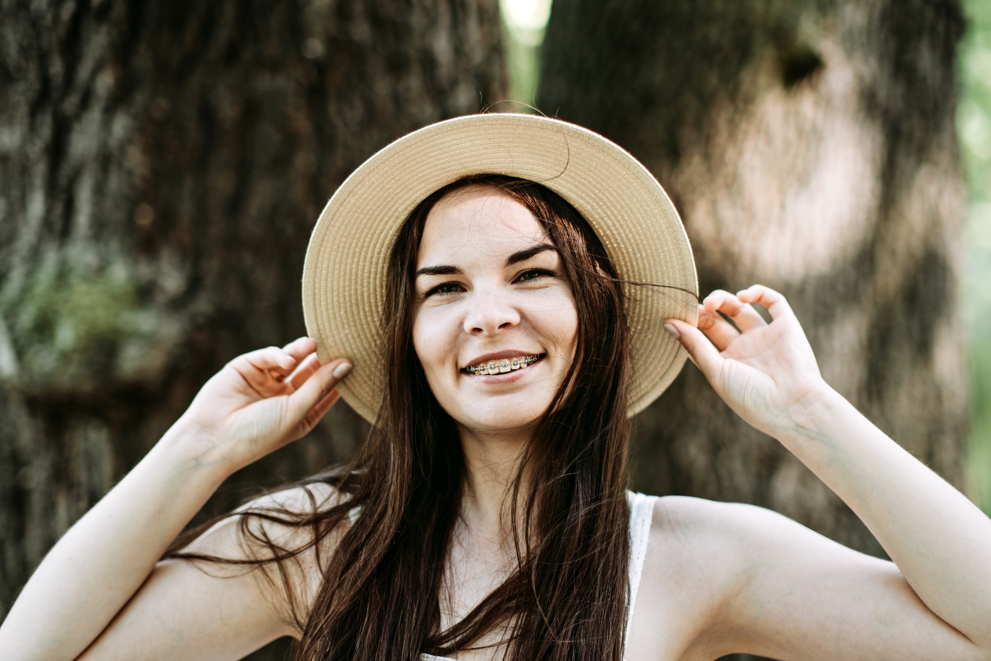 Candid portrait of beautiful happy smiling young woman with braces