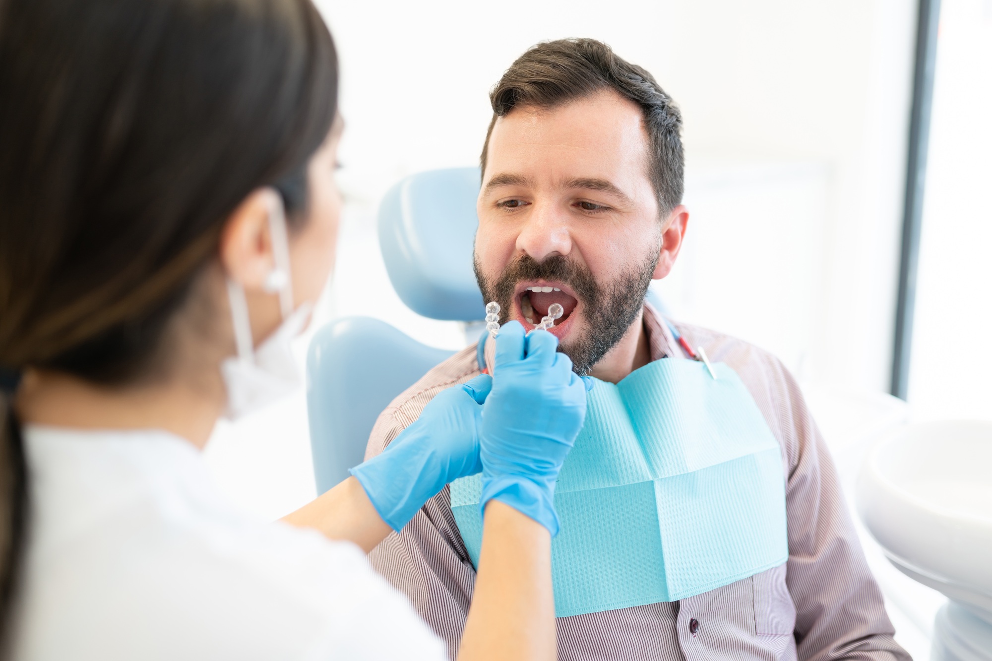 Dentist Examining Patient At Orthodontic Clinic