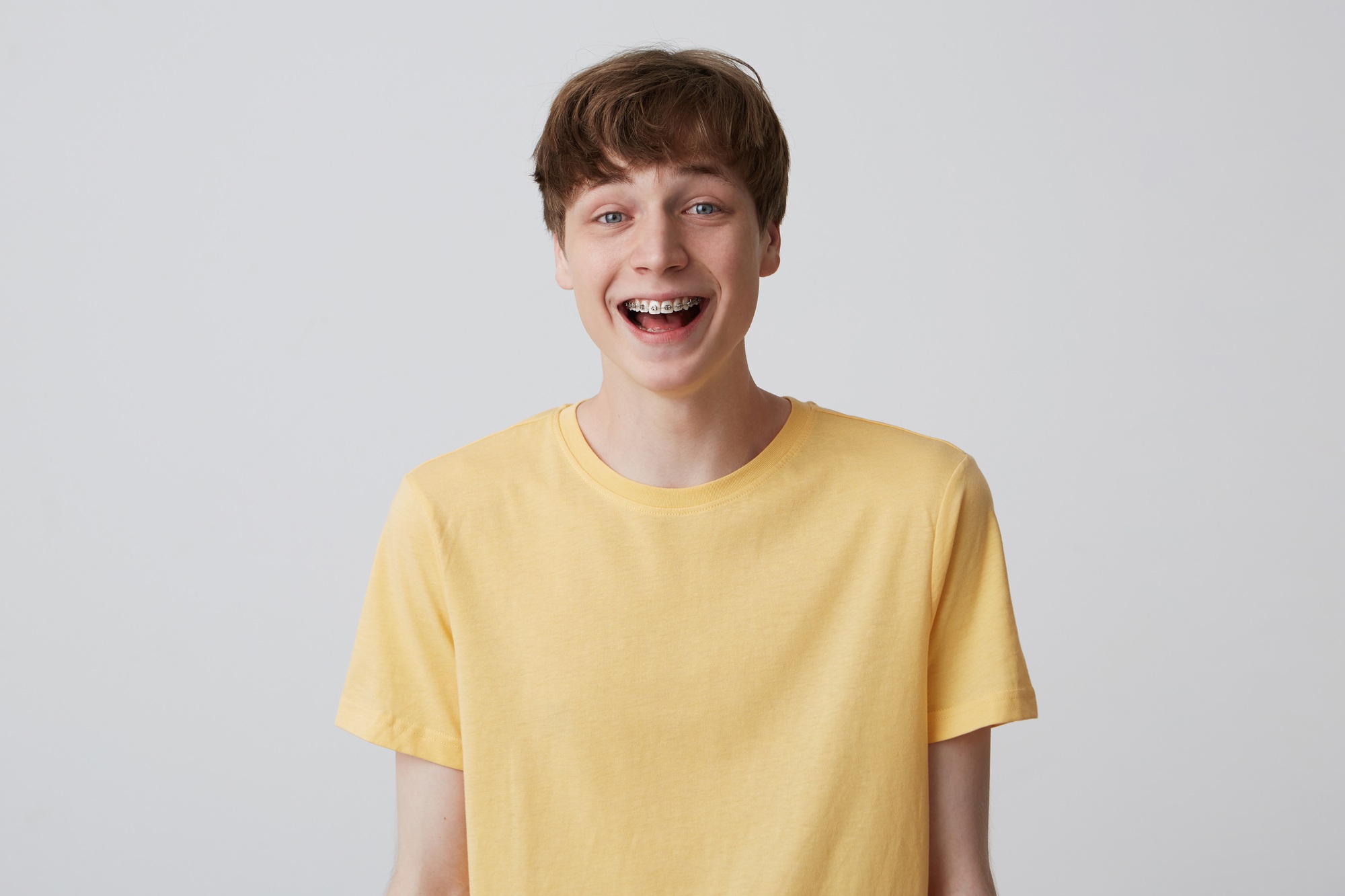 young man student with metal braces on teeth